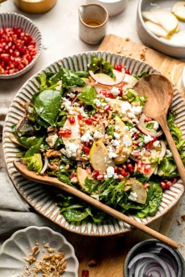 Pomegranate pear salad with walnuts, tangy cheese, and honey balsamic dressing is fresh, colorful, and perfect for holidays or everyday meals. | aheadofthyme.com