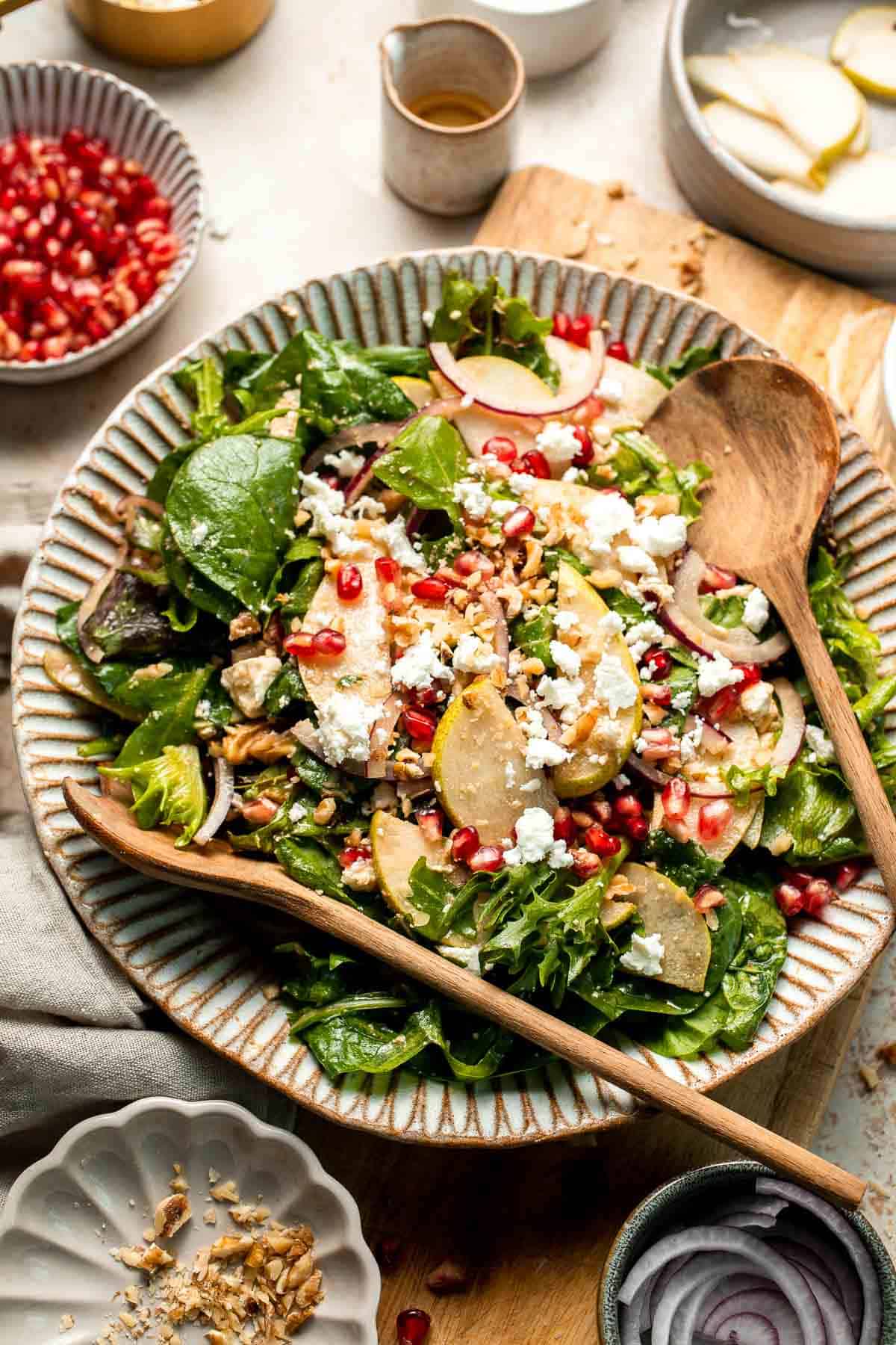 Pomegranate pear salad with walnuts, tangy cheese, and honey balsamic dressing is fresh, colorful, and perfect for holidays or everyday meals. | aheadofthyme.com