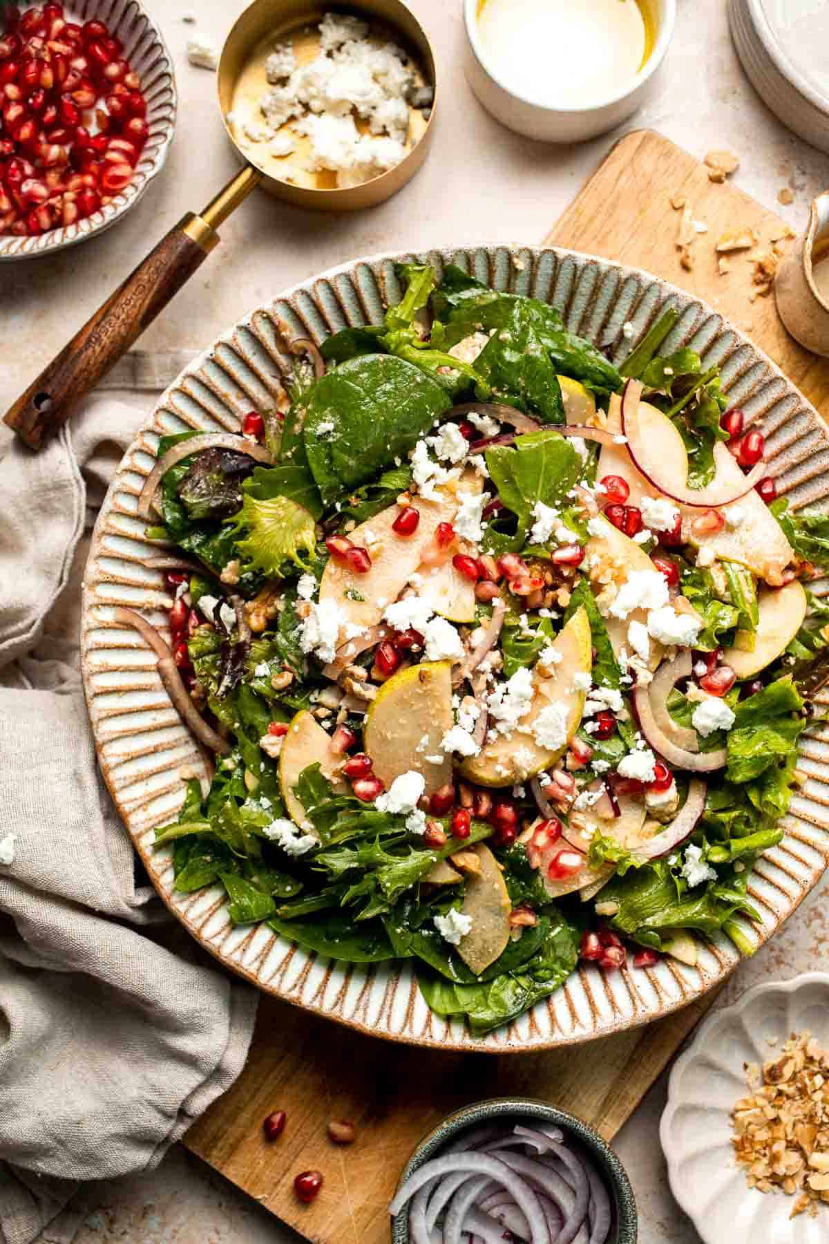 Pomegranate pear salad with walnuts, tangy cheese, and honey balsamic dressing is fresh, colorful, and perfect for holidays or everyday meals. | aheadofthyme.com
