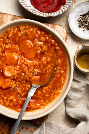 Looking for a hearty and healthy meal? This vegan red lentil soup with carrots is an easy one pot lunch or dinner packed with protein and flavor. | aheadofthyme.com