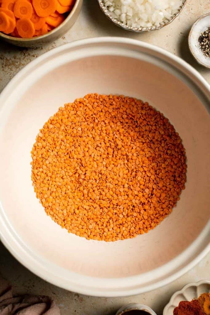 Looking for a hearty and healthy meal? This vegan red lentil soup with carrots is an easy one pot lunch or dinner packed with protein and flavor. | aheadofthyme.com