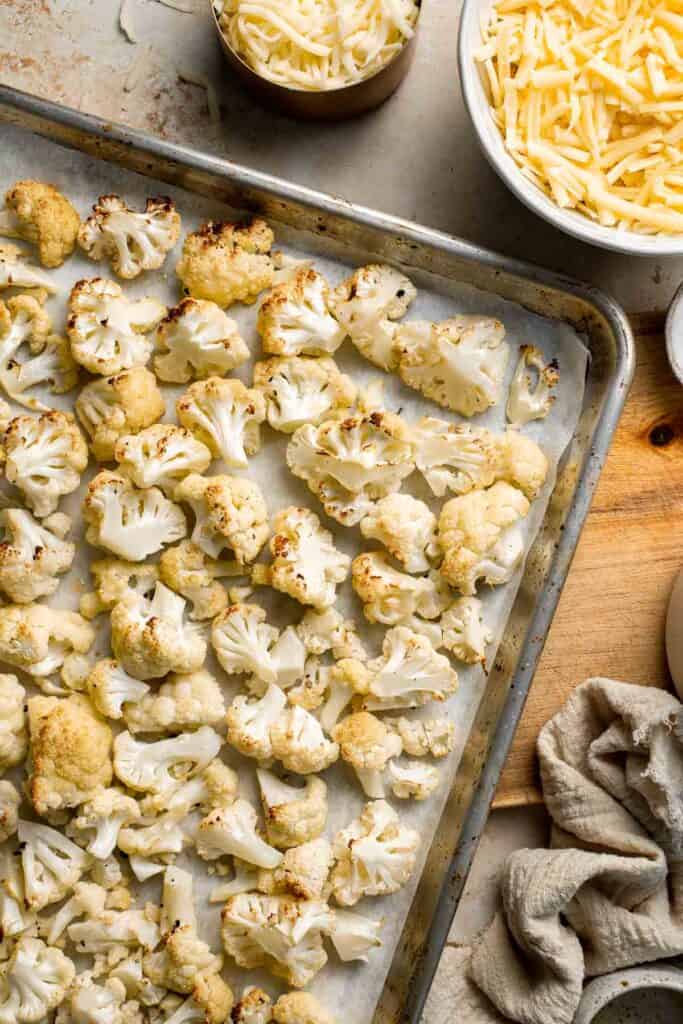 Easy Baked Cauliflower Cheese is the ultimate creamy, cheesy, golden comfort food side dish made with roasted cauliflower and rich homemade cheese sauce. | aheadofthyme.com