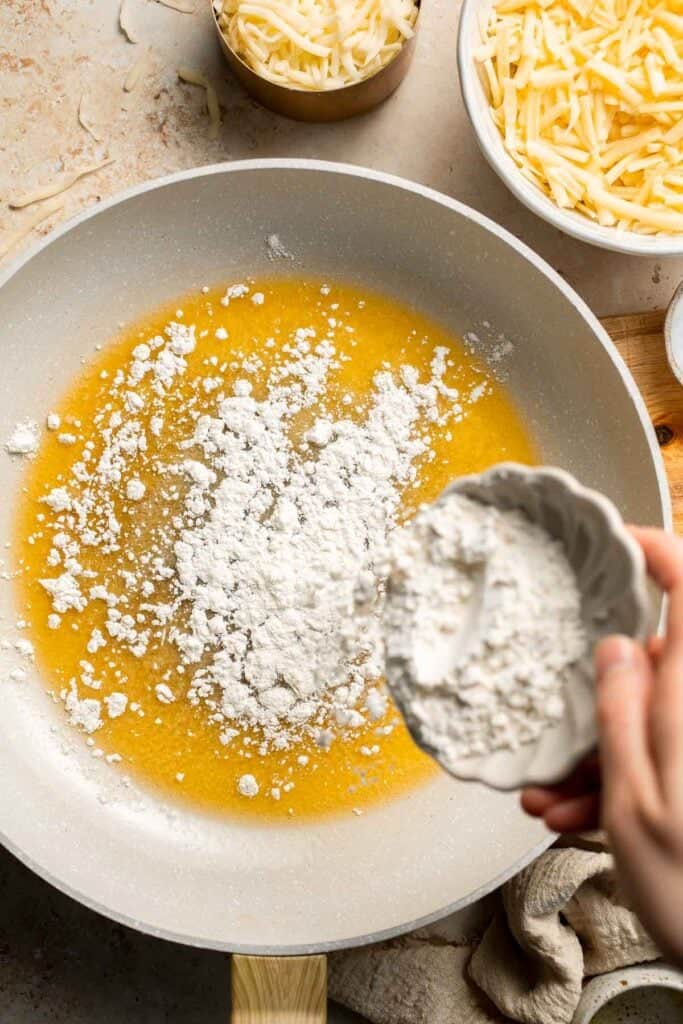 Easy Baked Cauliflower Cheese is the ultimate creamy, cheesy, golden comfort food side dish made with roasted cauliflower and rich homemade cheese sauce. | aheadofthyme.com