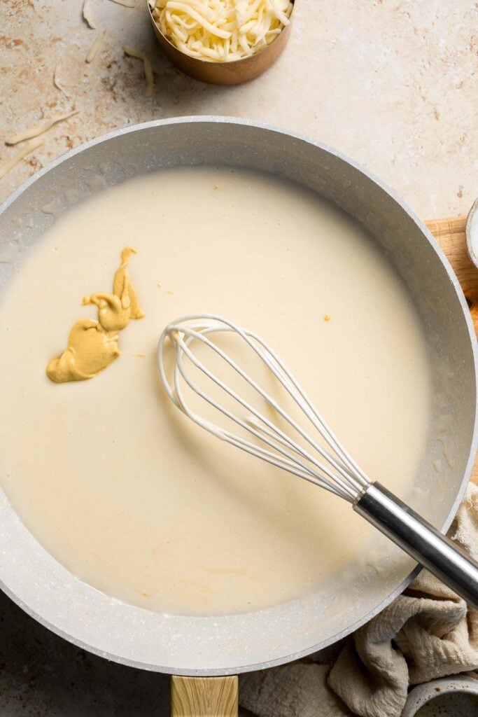 Easy Baked Cauliflower Cheese is the ultimate creamy, cheesy, golden comfort food side dish made with roasted cauliflower and rich homemade cheese sauce. | aheadofthyme.com
