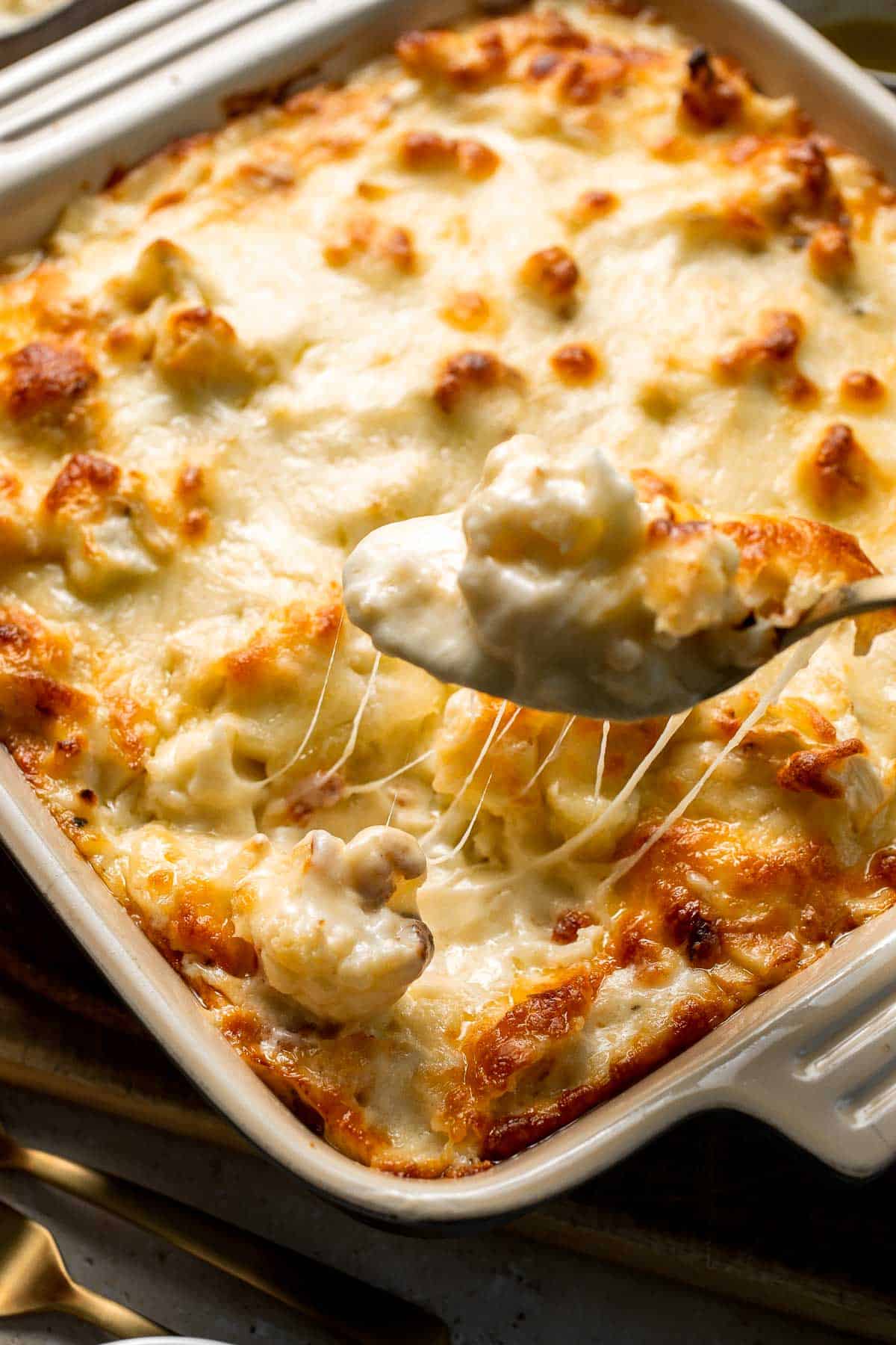 Easy Baked Cauliflower Cheese is the ultimate creamy, cheesy, golden comfort food side dish made with roasted cauliflower and rich homemade cheese sauce. | aheadofthyme.com