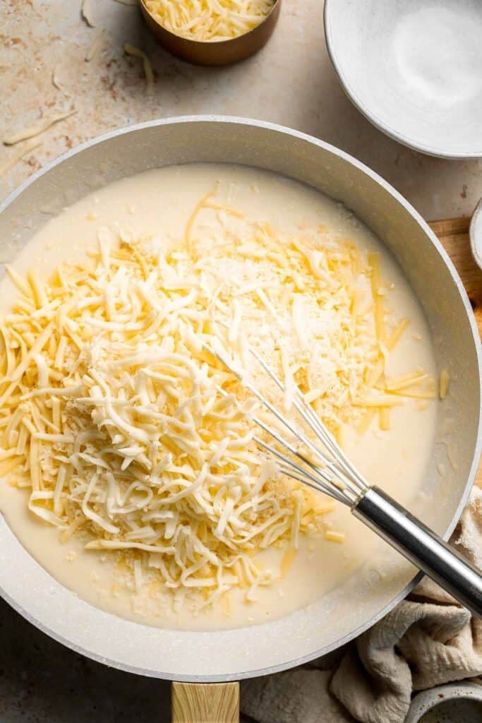 Easy Baked Cauliflower Cheese is the ultimate creamy, cheesy, golden comfort food side dish made with roasted cauliflower and rich homemade cheese sauce. | aheadofthyme.com