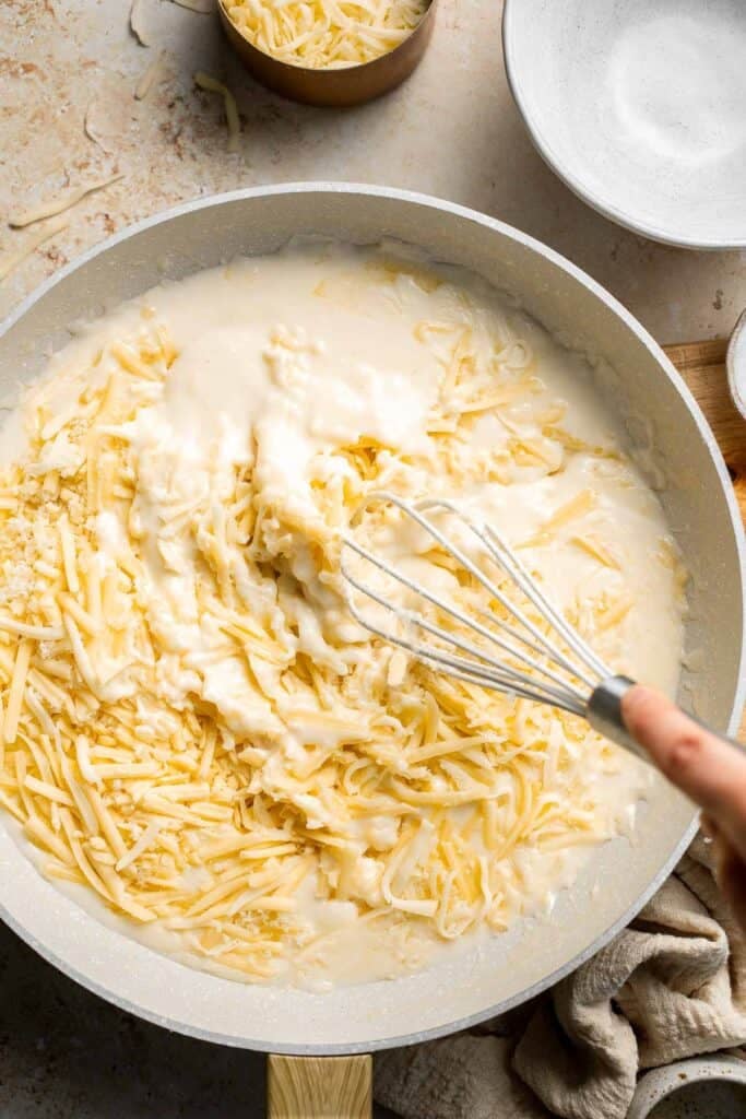 Easy Baked Cauliflower Cheese is the ultimate creamy, cheesy, golden comfort food side dish made with roasted cauliflower and rich homemade cheese sauce. | aheadofthyme.com