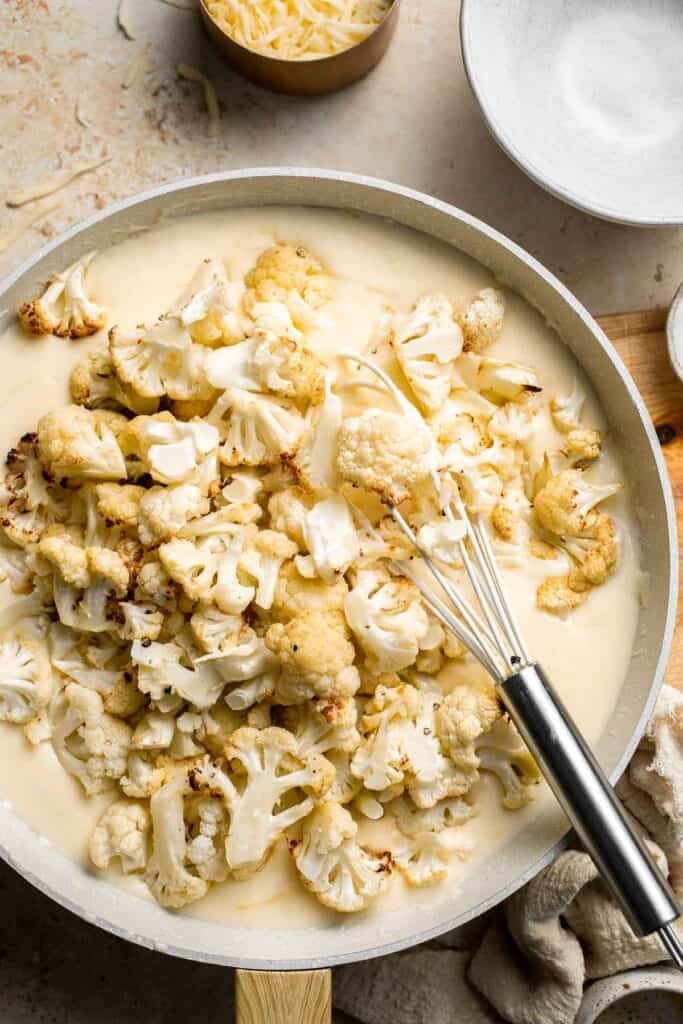 Easy Baked Cauliflower Cheese is the ultimate creamy, cheesy, golden comfort food side dish made with roasted cauliflower and rich homemade cheese sauce. | aheadofthyme.com