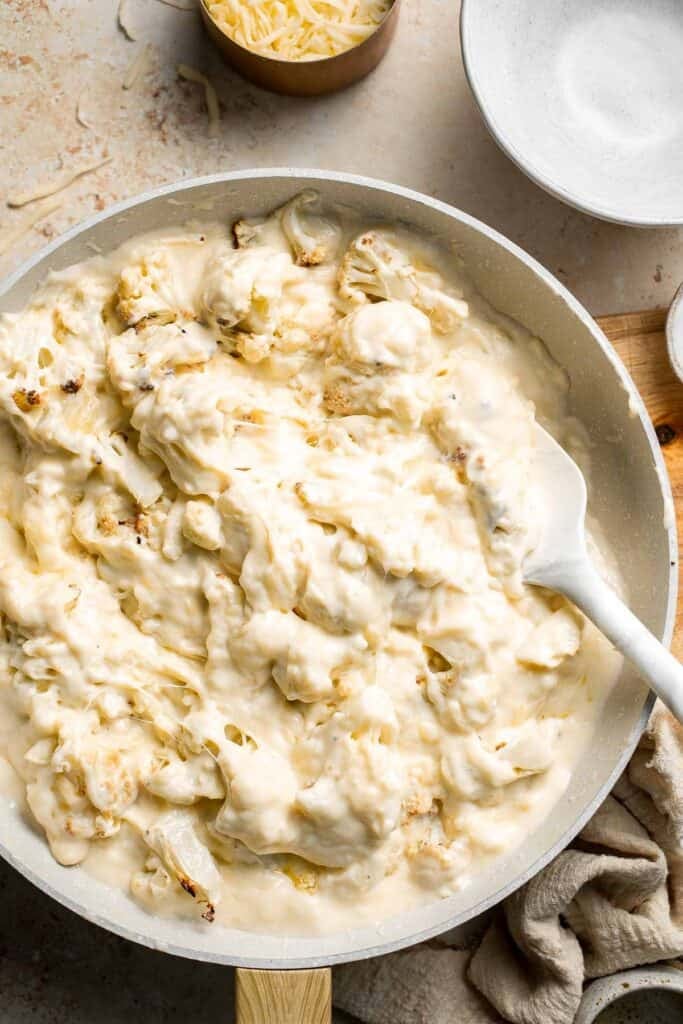 Easy Baked Cauliflower Cheese is the ultimate creamy, cheesy, golden comfort food side dish made with roasted cauliflower and rich homemade cheese sauce. | aheadofthyme.com