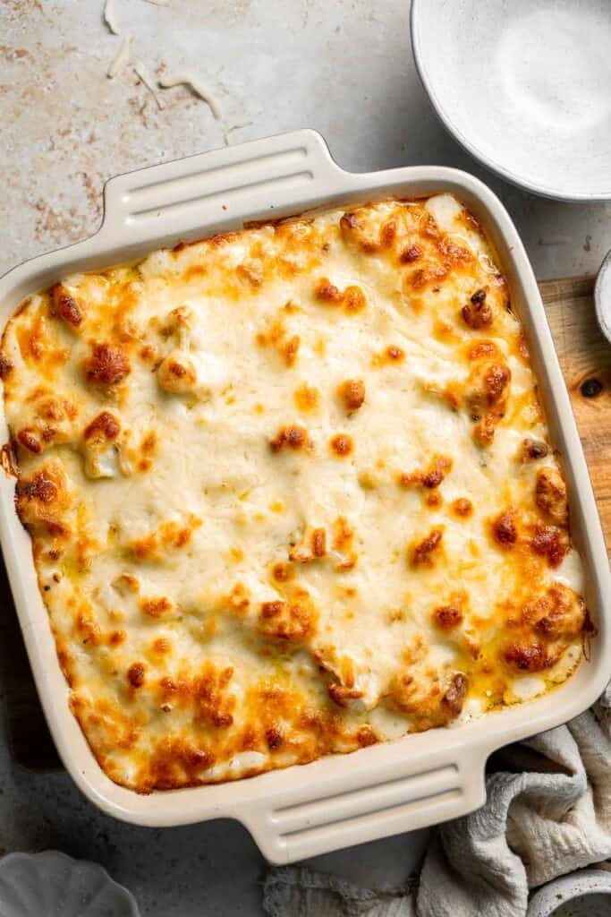 Easy Baked Cauliflower Cheese is the ultimate creamy, cheesy, golden comfort food side dish made with roasted cauliflower and rich homemade cheese sauce. | aheadofthyme.com