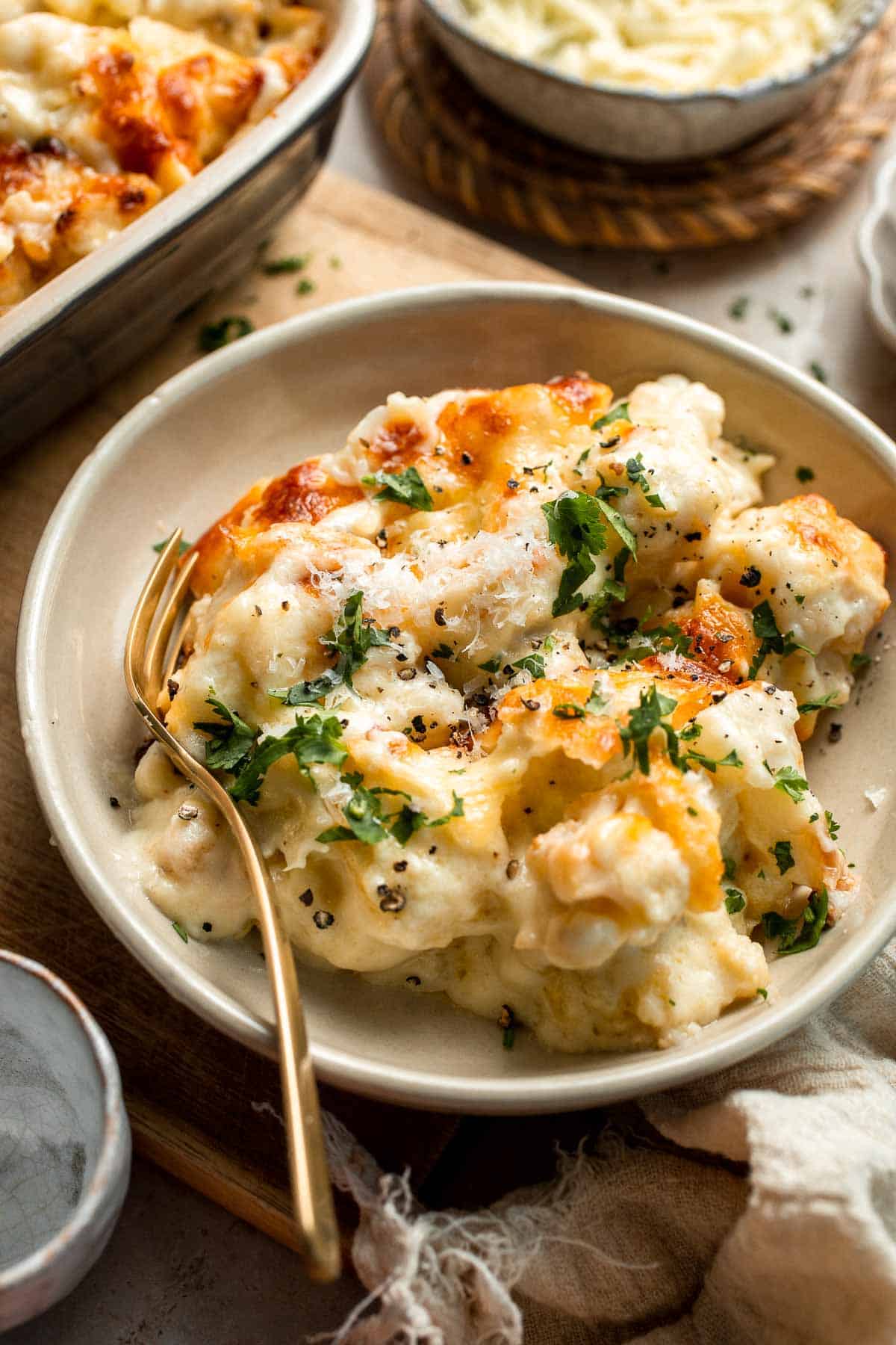Easy Baked Cauliflower Cheese is the ultimate creamy, cheesy, golden comfort food side dish made with roasted cauliflower and rich homemade cheese sauce. | aheadofthyme.com