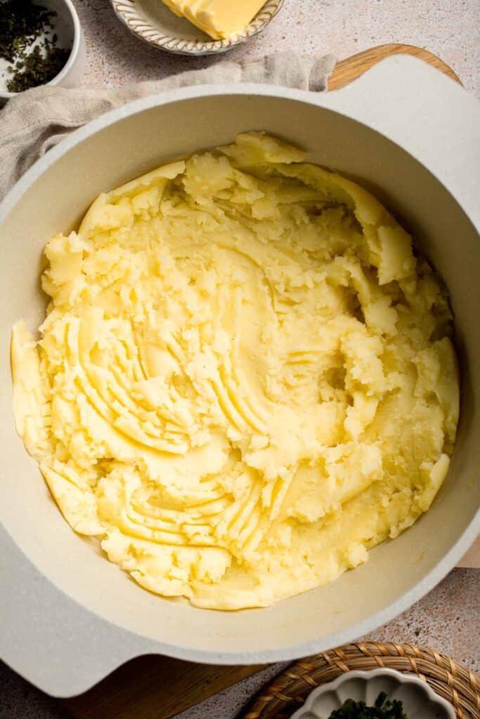 Creamy Garlic Herb Mashed Potatoes are buttery, flavorful, and easy to make. The perfect side dish for holidays or weeknight dinners. | aheadofthyme.com