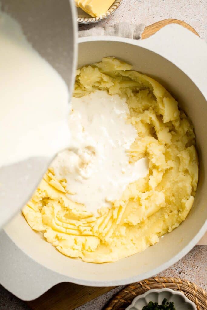 Creamy Garlic Herb Mashed Potatoes are buttery, flavorful, and easy to make. The perfect side dish for holidays or weeknight dinners. | aheadofthyme.com
