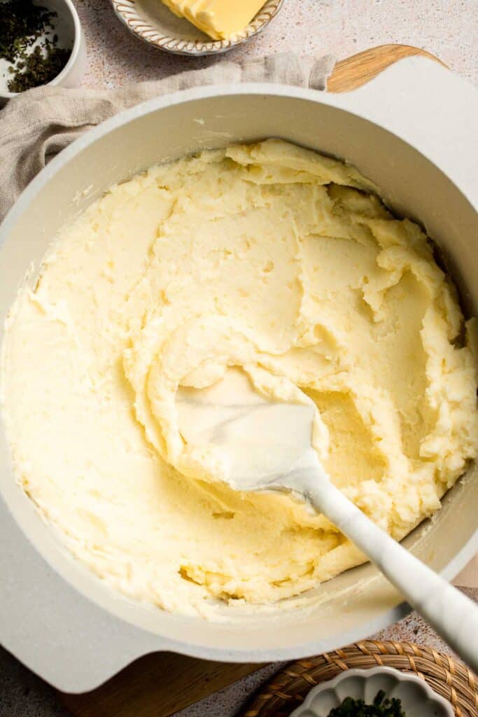 Creamy Garlic Herb Mashed Potatoes are buttery, flavorful, and easy to make. The perfect side dish for holidays or weeknight dinners. | aheadofthyme.com