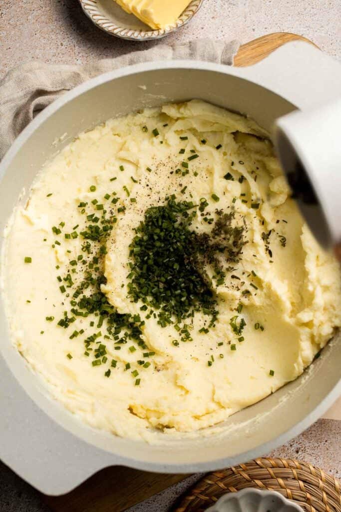 Creamy Garlic Herb Mashed Potatoes are buttery, flavorful, and easy to make. The perfect side dish for holidays or weeknight dinners. | aheadofthyme.com