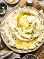 Creamy Garlic Herb Mashed Potatoes are buttery, flavorful, and easy to make. The perfect side dish for holidays or weeknight dinners. | aheadofthyme.com