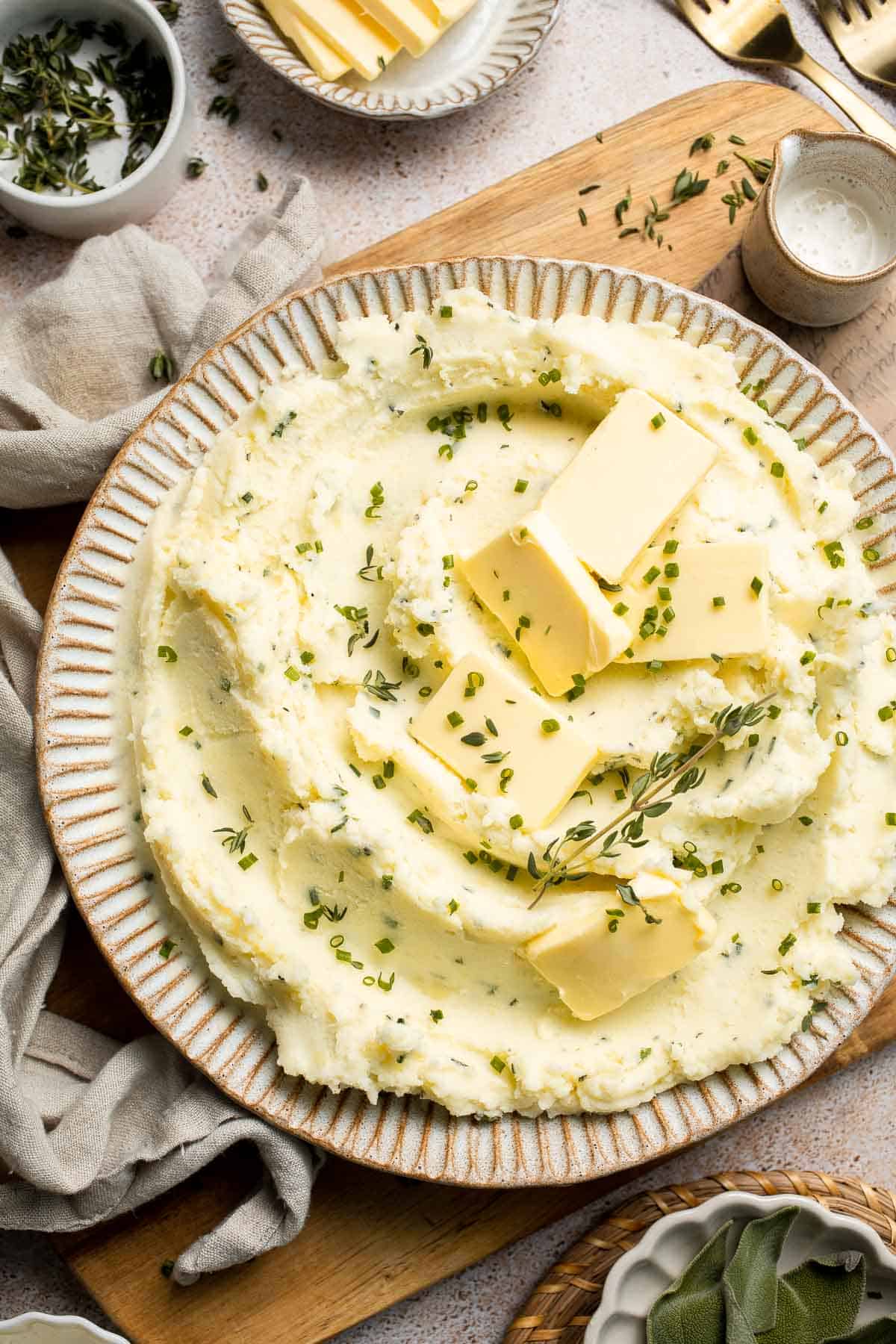 Creamy Garlic Herb Mashed Potatoes are buttery, flavorful, and easy to make. The perfect side dish for holidays or weeknight dinners. | aheadofthyme.com