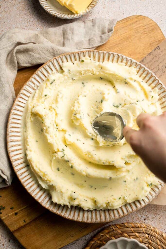 Creamy Garlic Herb Mashed Potatoes are buttery, flavorful, and easy to make. The perfect side dish for holidays or weeknight dinners. | aheadofthyme.com