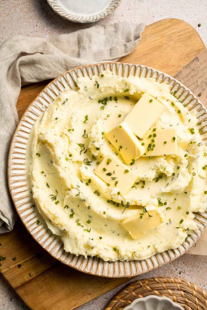 Creamy Garlic Herb Mashed Potatoes are buttery, flavorful, and easy to make. The perfect side dish for holidays or weeknight dinners. | aheadofthyme.com