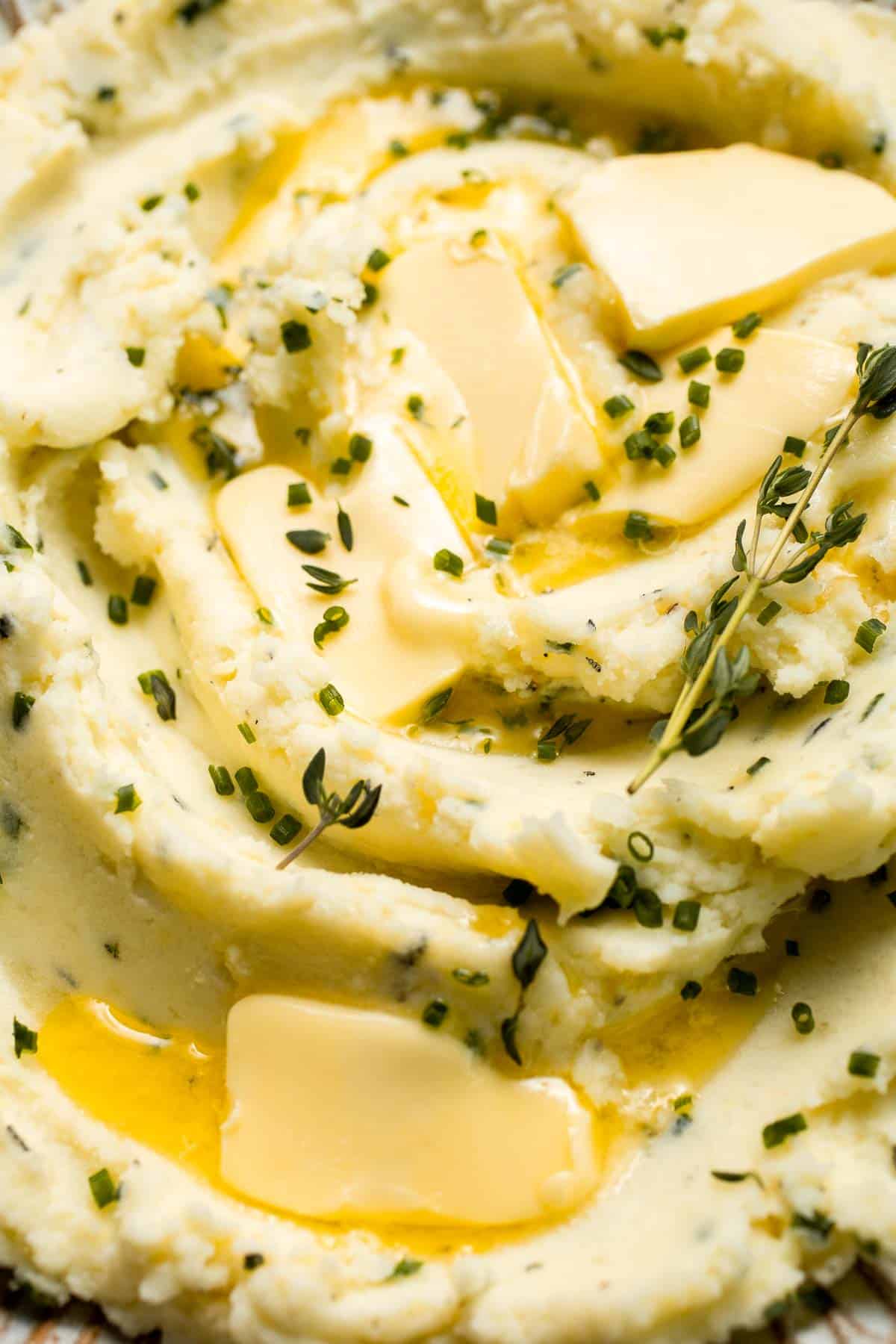 Creamy Garlic Herb Mashed Potatoes are buttery, flavorful, and easy to make. The perfect side dish for holidays or weeknight dinners. | aheadofthyme.com