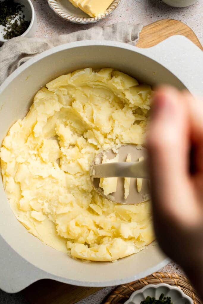 Creamy Garlic Herb Mashed Potatoes are buttery, flavorful, and easy to make. The perfect side dish for holidays or weeknight dinners. | aheadofthyme.com