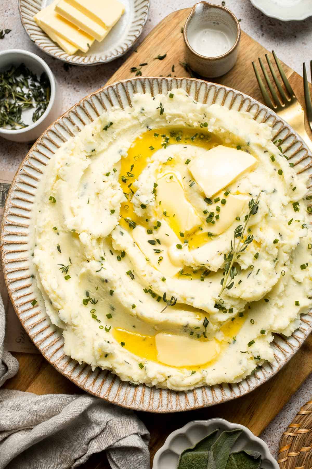 Creamy Garlic Herb Mashed Potatoes are buttery, flavorful, and easy to make. The perfect side dish for holidays or weeknight dinners. | aheadofthyme.com