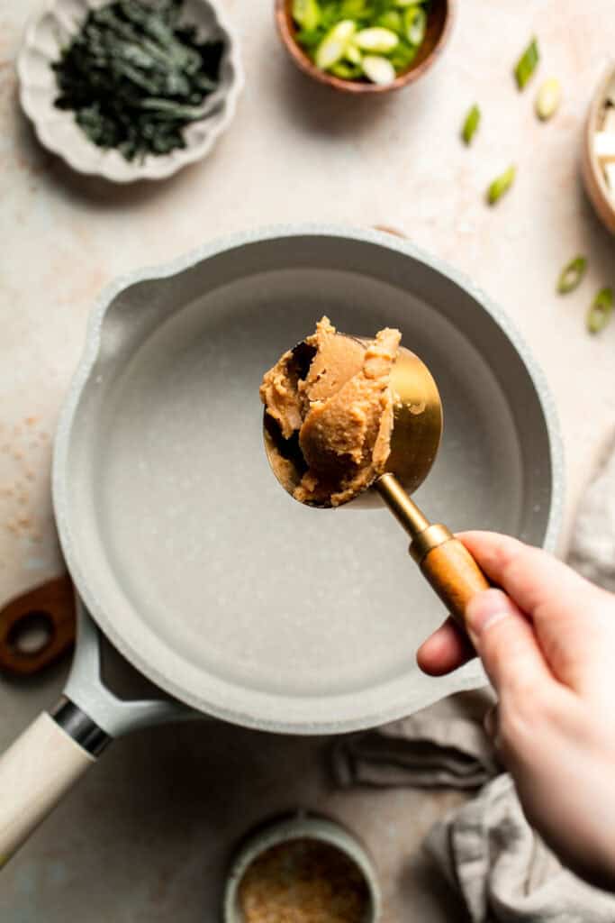 Learn how to make nourishing homemade miso soup with tofu. This traditional Japanese recipe is packed with umami flavor and easy to make in 10 minutes. | aheadofthyme.com