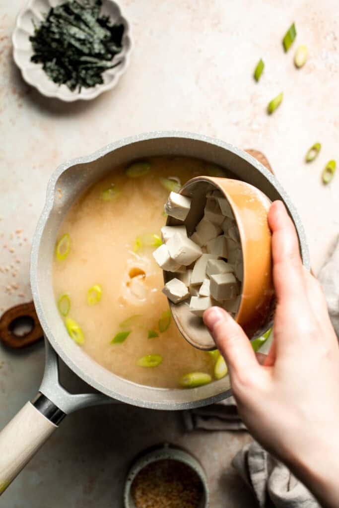 Learn how to make nourishing homemade miso soup with tofu. This traditional Japanese recipe is packed with umami flavor and easy to make in 10 minutes. | aheadofthyme.com