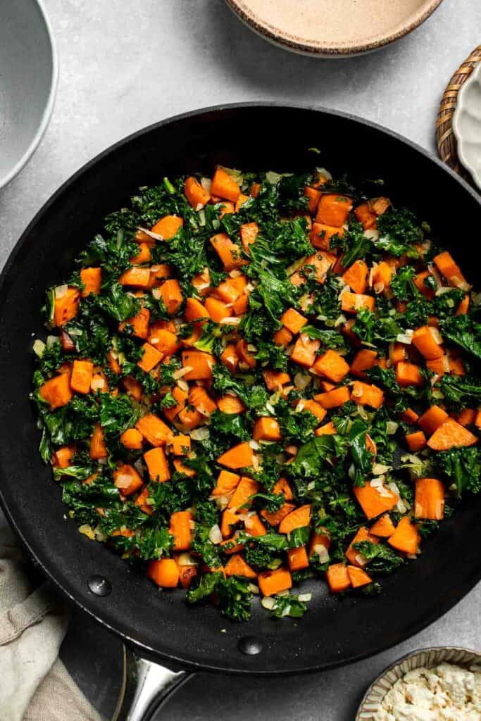 Kale and Sweet Potato Frittata is a protein-packed, one-pan meal with nutrient-dense kale, sweet potatoes, and creamy feta in a fluffy egg base. | aheadofthyme.com