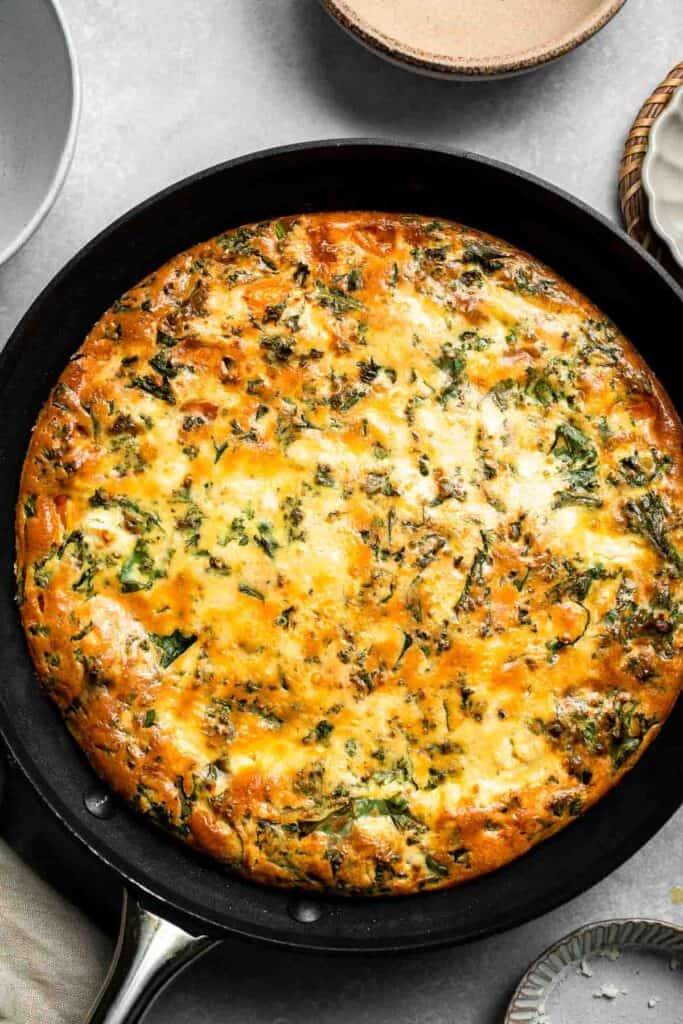 Kale and Sweet Potato Frittata is a protein-packed, one-pan meal with nutrient-dense kale, sweet potatoes, and creamy feta in a fluffy egg base. | aheadofthyme.com