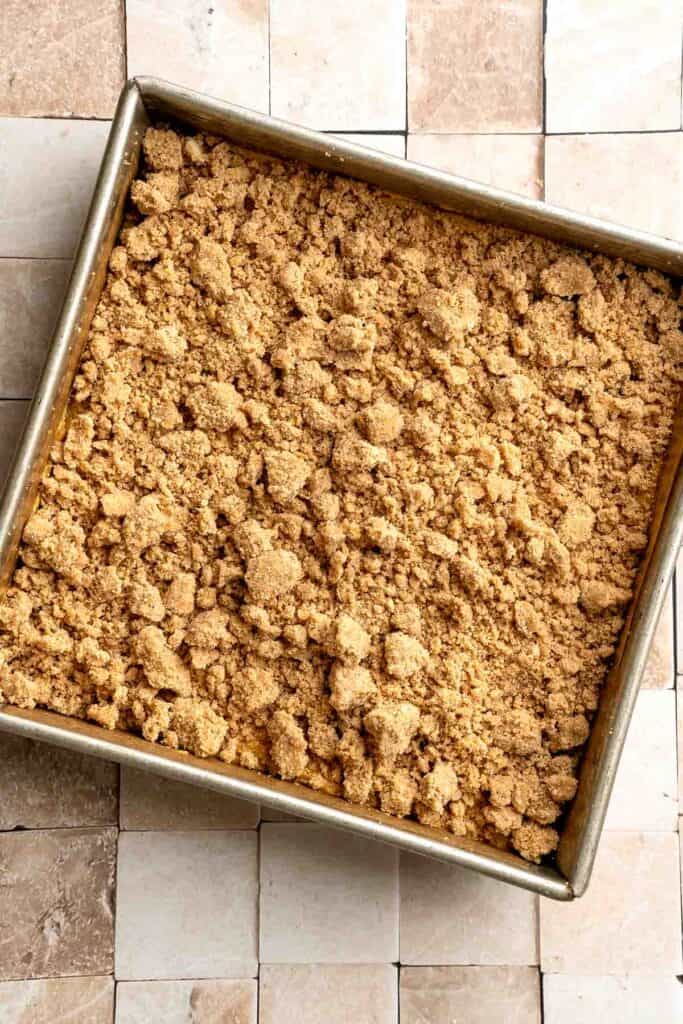 Pumpkin Coffee Cake, topped with a sweet and crunchy streusel and a maple glaze drizzle, is soft, moist, and filled with warm fall spices. | aheadofthyme.com