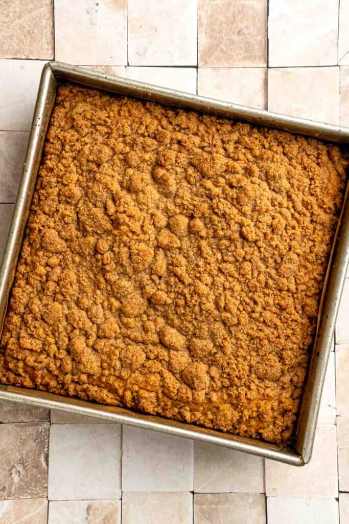 Pumpkin Coffee Cake, topped with a sweet and crunchy streusel and a maple glaze drizzle, is soft, moist, and filled with warm fall spices. | aheadofthyme.com