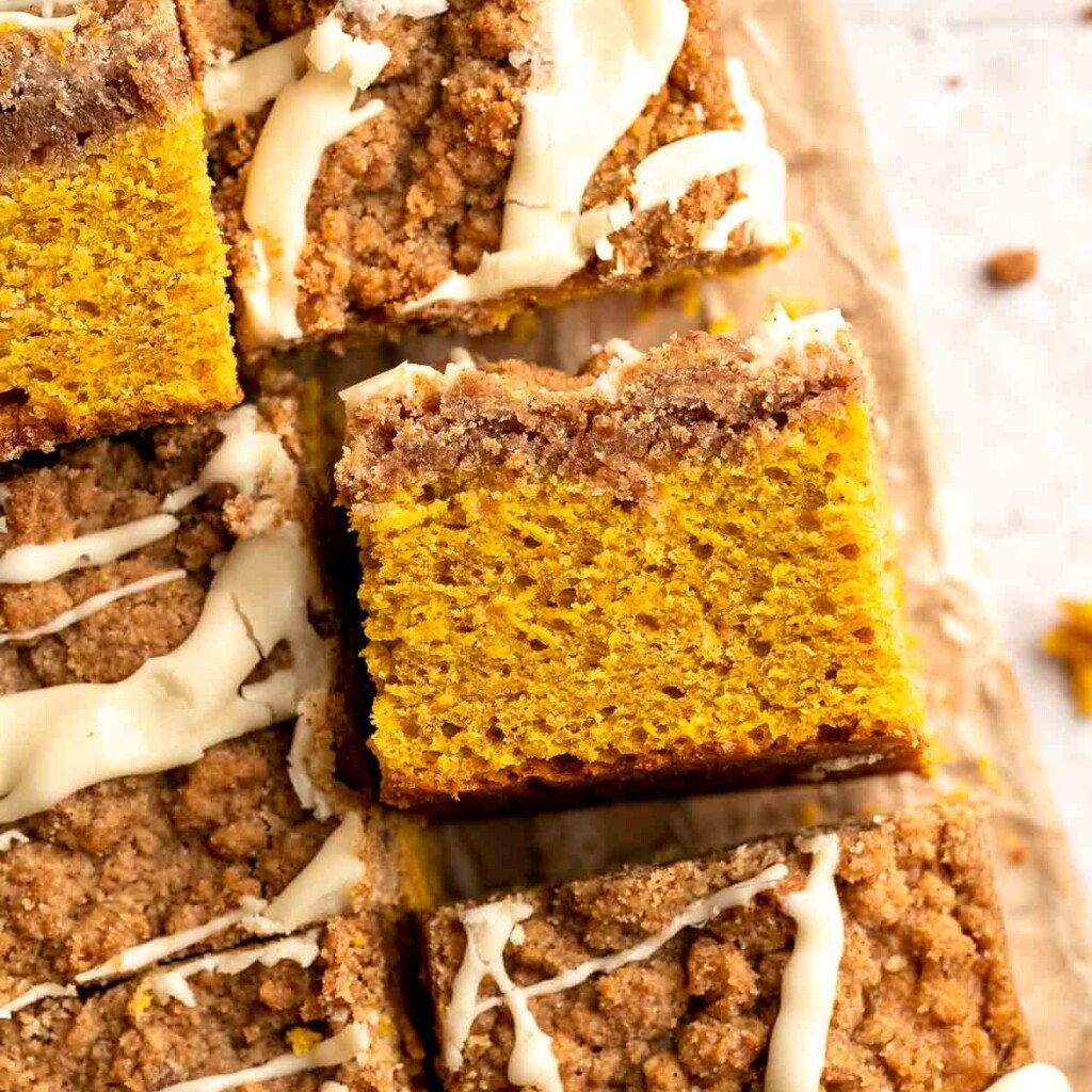 Pumpkin Coffee Cake, topped with a sweet and crunchy streusel and a maple glaze drizzle, is soft, moist, and filled with warm fall spices. | aheadofthyme.com