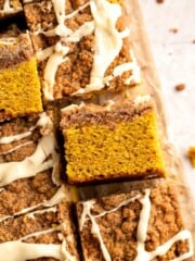 Pumpkin Coffee Cake, topped with a sweet and crunchy streusel and a maple glaze drizzle, is soft, moist, and filled with warm fall spices. | aheadofthyme.com
