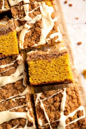 Pumpkin Coffee Cake, topped with a sweet and crunchy streusel and a maple glaze drizzle, is soft, moist, and filled with warm fall spices. | aheadofthyme.com