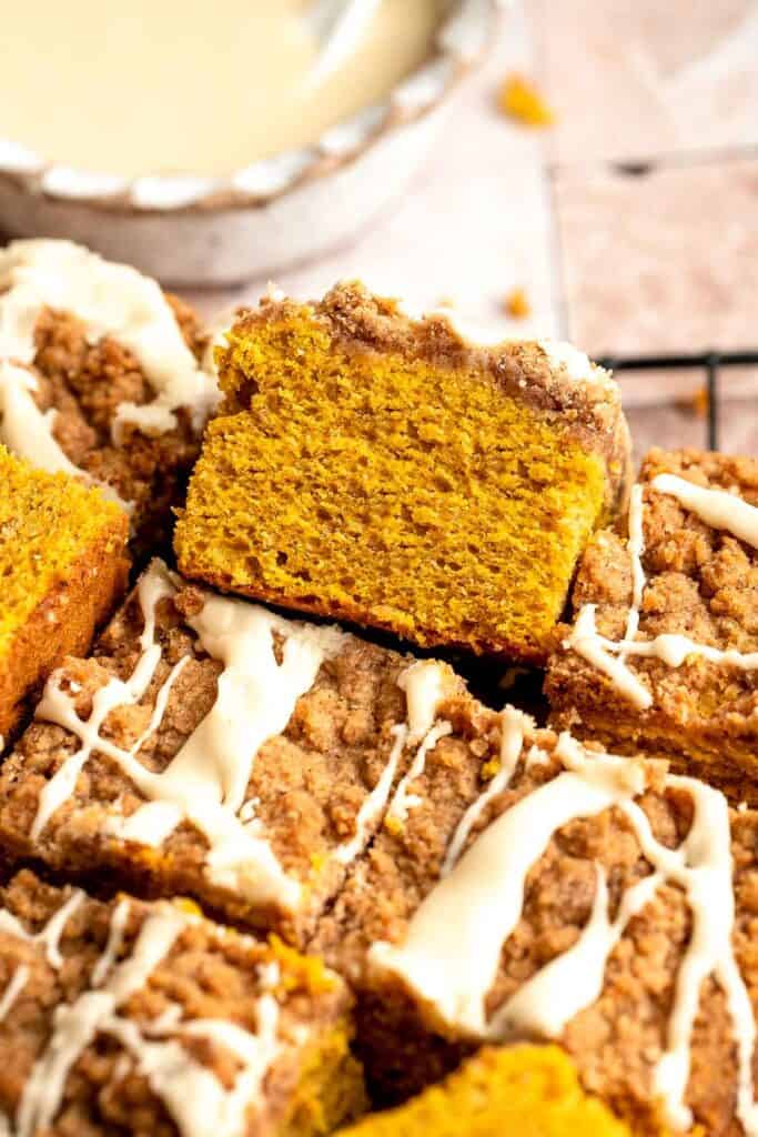 Pumpkin Coffee Cake, topped with a sweet and crunchy streusel and a maple glaze drizzle, is soft, moist, and filled with warm fall spices. | aheadofthyme.com