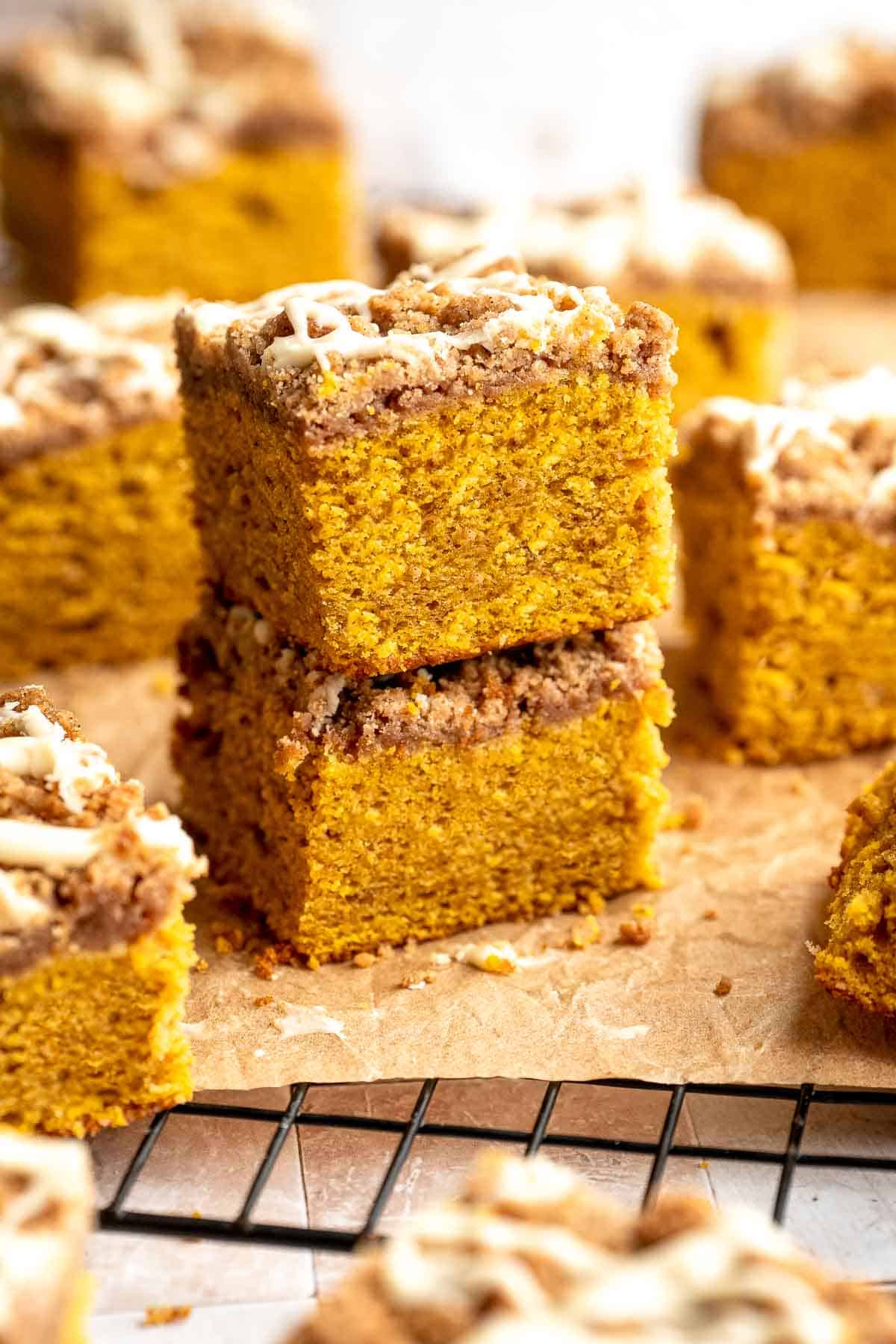 Pumpkin Coffee Cake, topped with a sweet and crunchy streusel and a maple glaze drizzle, is soft, moist, and filled with warm fall spices. | aheadofthyme.com
