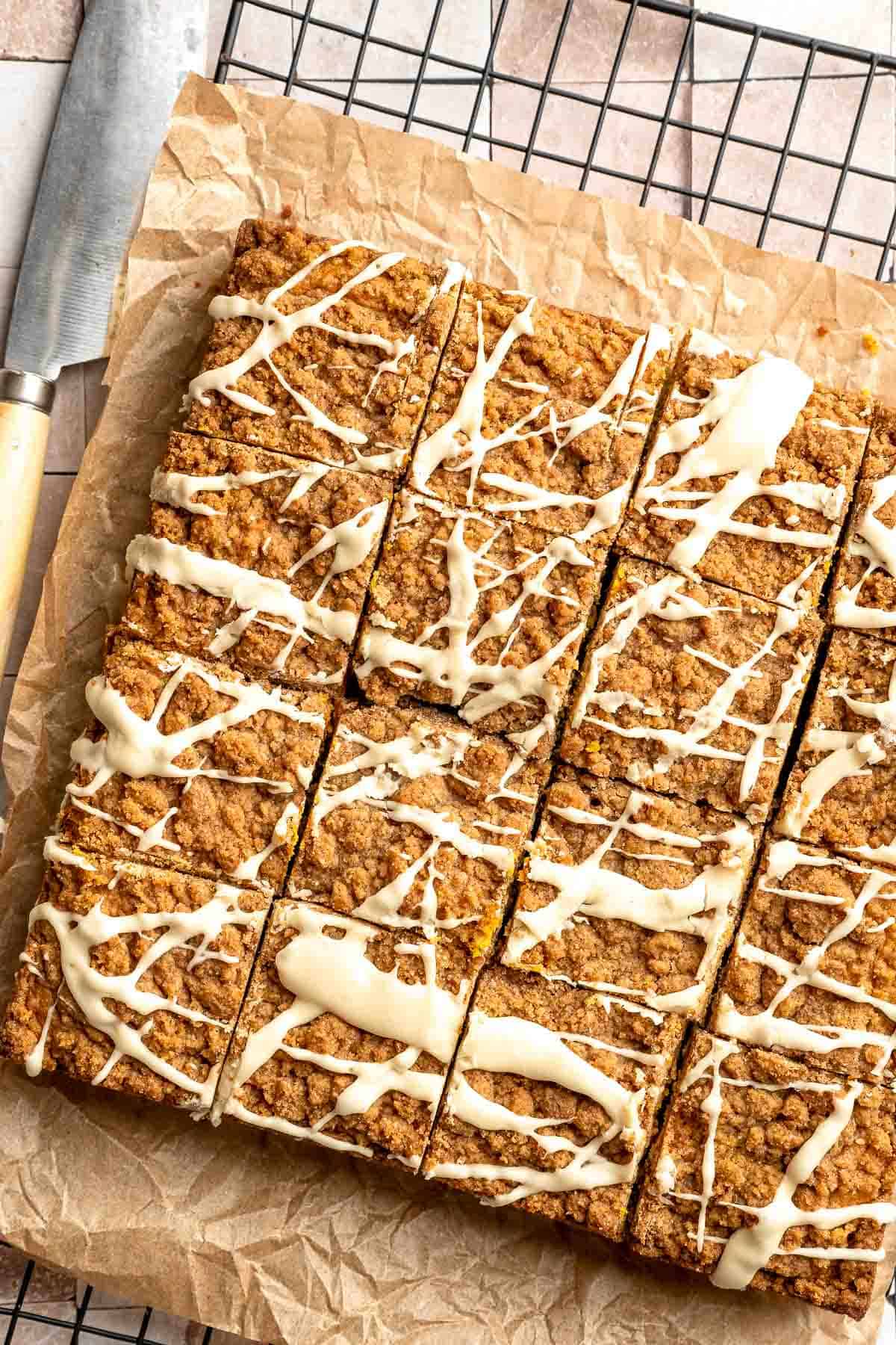 Pumpkin Coffee Cake, topped with a sweet and crunchy streusel and a maple glaze drizzle, is soft, moist, and filled with warm fall spices. | aheadofthyme.com