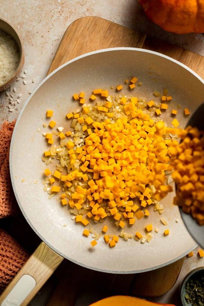 Enjoy a taste of fall with this creamy pumpkin risotto made with arborio rice, savory pumpkin, and aromatic herbs for a cozy, flavorful dish. | aheadofthyme.com
