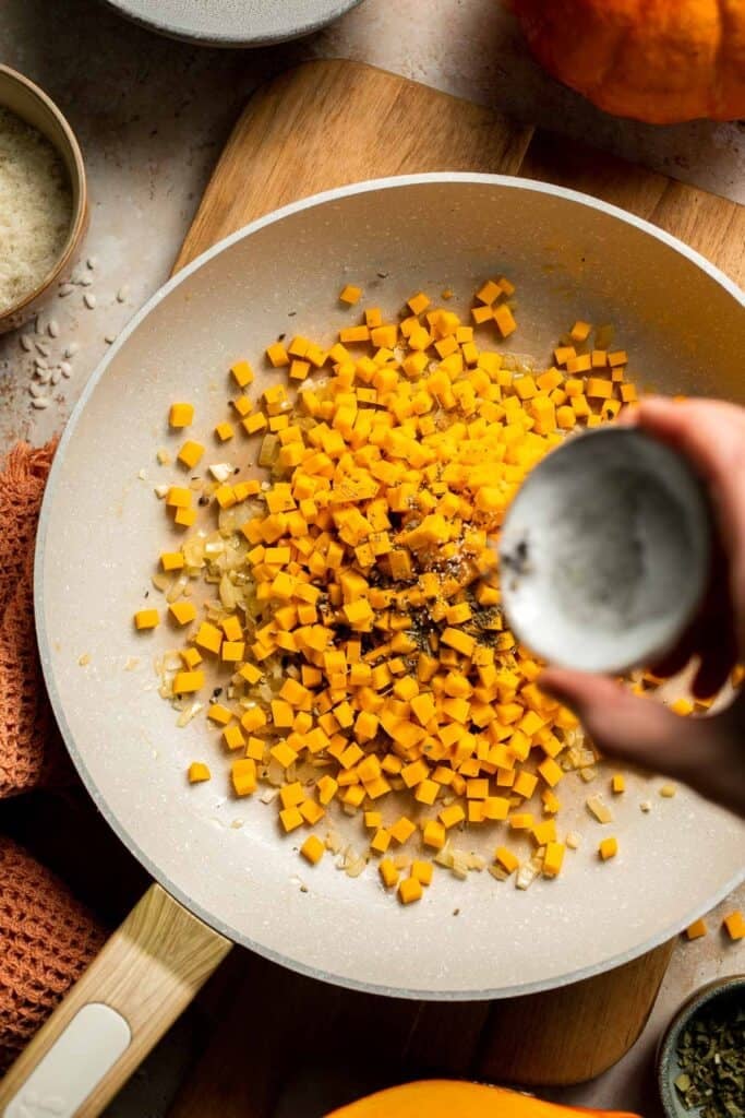 Enjoy a taste of fall with this creamy pumpkin risotto made with arborio rice, savory pumpkin, and aromatic herbs for a cozy, flavorful dish. | aheadofthyme.com