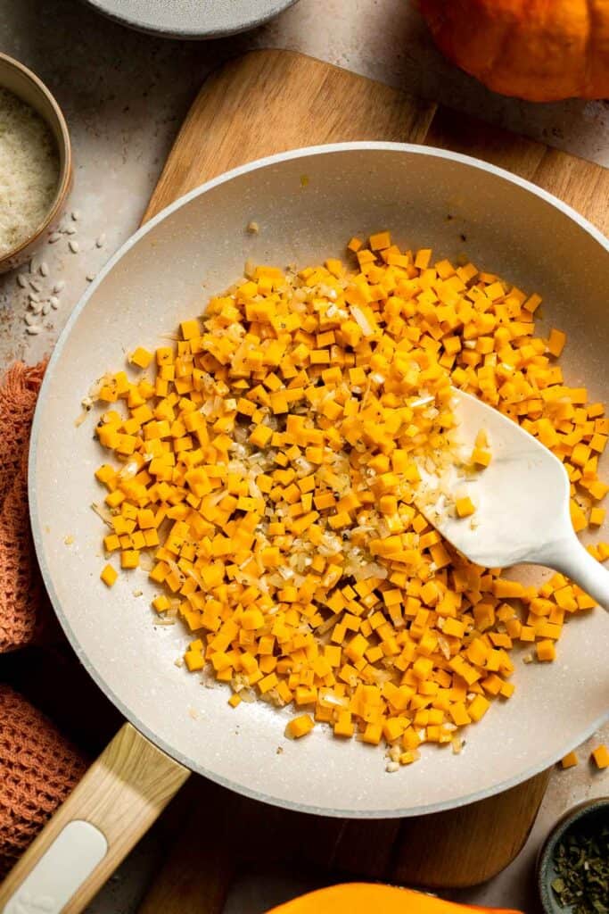 Enjoy a taste of fall with this creamy pumpkin risotto made with arborio rice, savory pumpkin, and aromatic herbs for a cozy, flavorful dish. | aheadofthyme.com