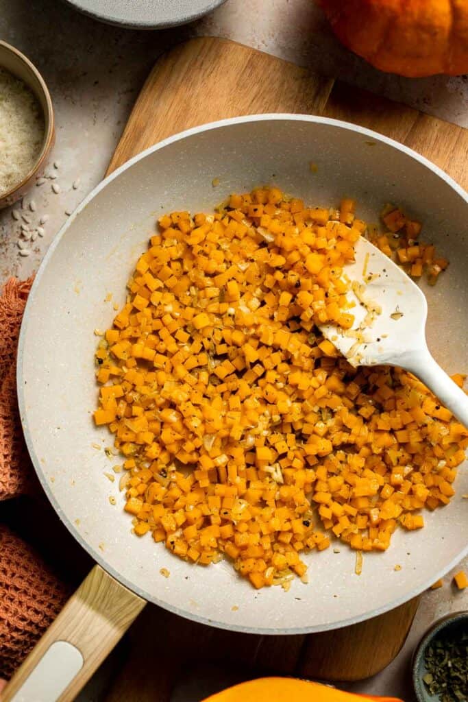 Enjoy a taste of fall with this creamy pumpkin risotto made with arborio rice, savory pumpkin, and aromatic herbs for a cozy, flavorful dish. | aheadofthyme.com