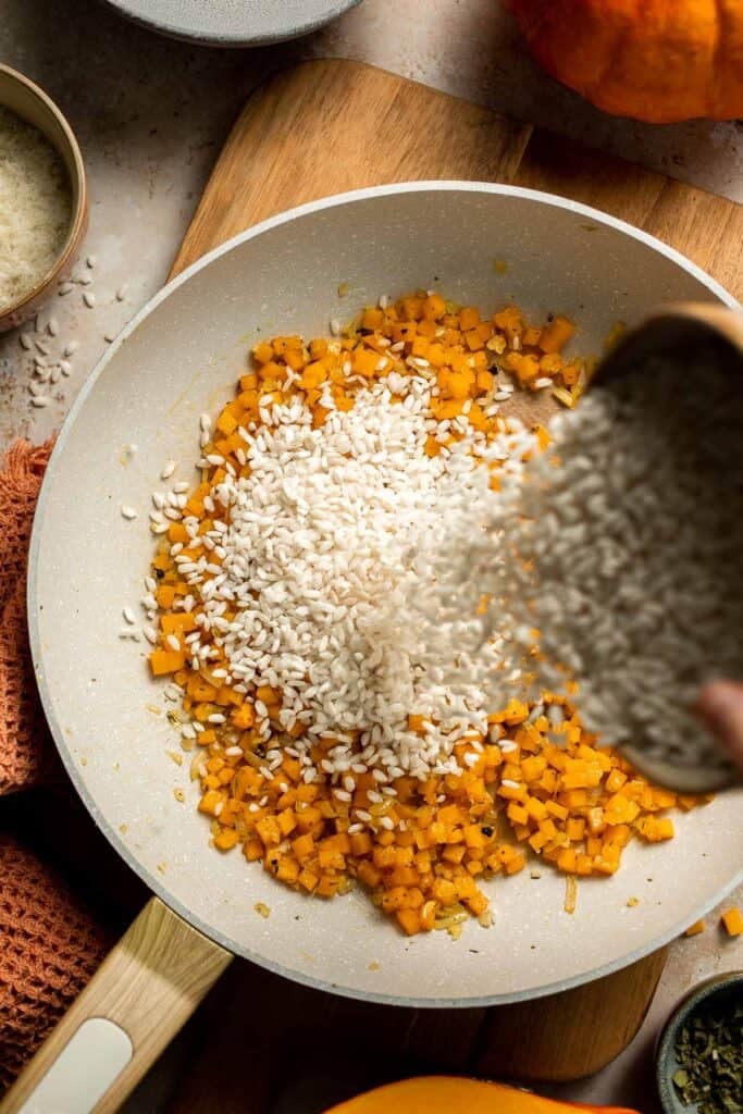 Enjoy a taste of fall with this creamy pumpkin risotto made with arborio rice, savory pumpkin, and aromatic herbs for a cozy, flavorful dish. | aheadofthyme.com