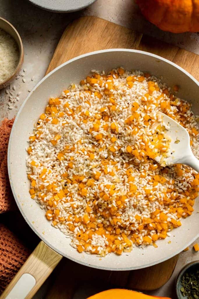 Enjoy a taste of fall with this creamy pumpkin risotto made with arborio rice, savory pumpkin, and aromatic herbs for a cozy, flavorful dish. | aheadofthyme.com