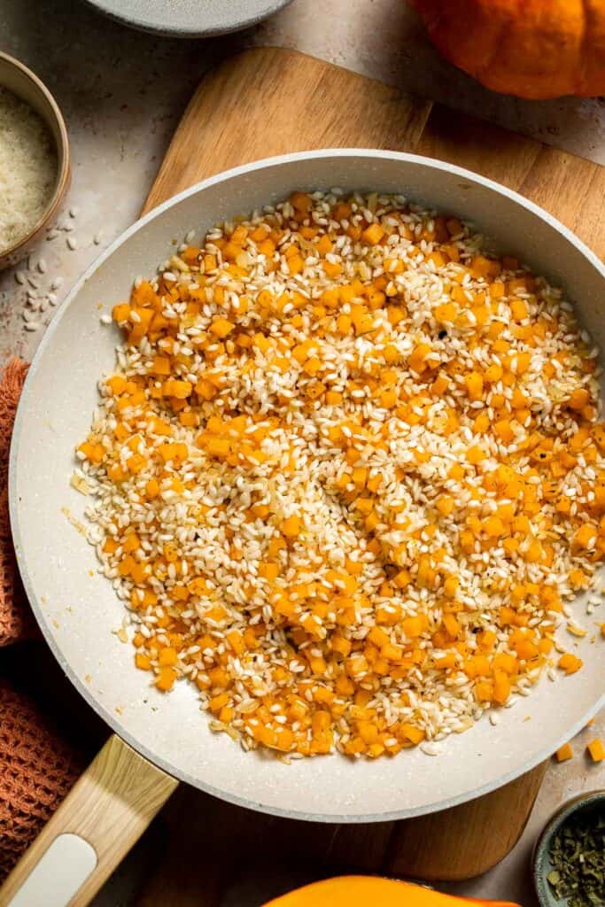 Enjoy a taste of fall with this creamy pumpkin risotto made with arborio rice, savory pumpkin, and aromatic herbs for a cozy, flavorful dish. | aheadofthyme.com