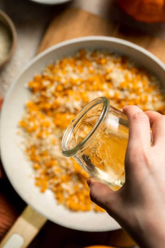 Enjoy a taste of fall with this creamy pumpkin risotto made with arborio rice, savory pumpkin, and aromatic herbs for a cozy, flavorful dish. | aheadofthyme.com