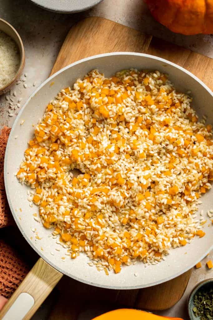 Enjoy a taste of fall with this creamy pumpkin risotto made with arborio rice, savory pumpkin, and aromatic herbs for a cozy, flavorful dish. | aheadofthyme.com