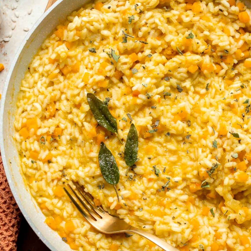 Enjoy a taste of fall with this creamy pumpkin risotto made with arborio rice, savory pumpkin, and aromatic herbs for a cozy, flavorful dish. | aheadofthyme.com