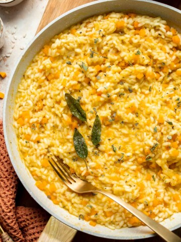 Enjoy a taste of fall with this creamy pumpkin risotto made with arborio rice, savory pumpkin, and aromatic herbs for a cozy, flavorful dish. | aheadofthyme.com
