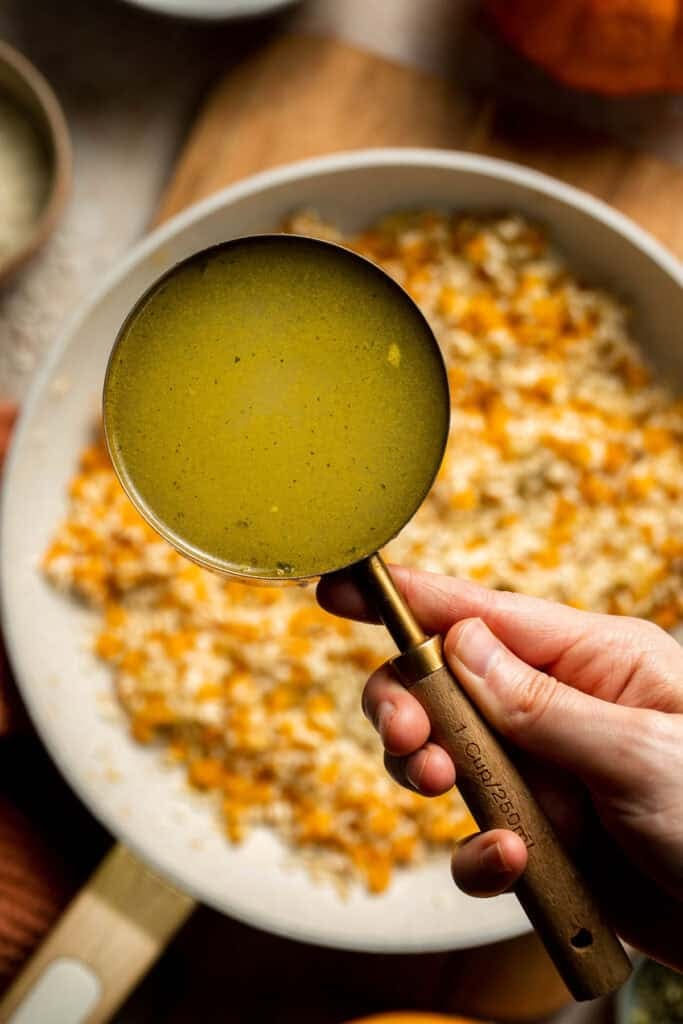 Enjoy a taste of fall with this creamy pumpkin risotto made with arborio rice, savory pumpkin, and aromatic herbs for a cozy, flavorful dish. | aheadofthyme.com